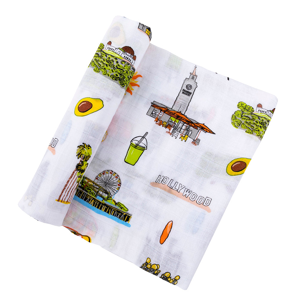 The Los Angeles muslin swaddle blanket, draped softly to show its city landmarks and palm trees.