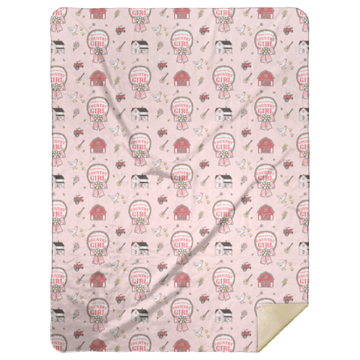 The soft pink Country Girl plush throw blanket printed with badges, one cream corner folded back.
