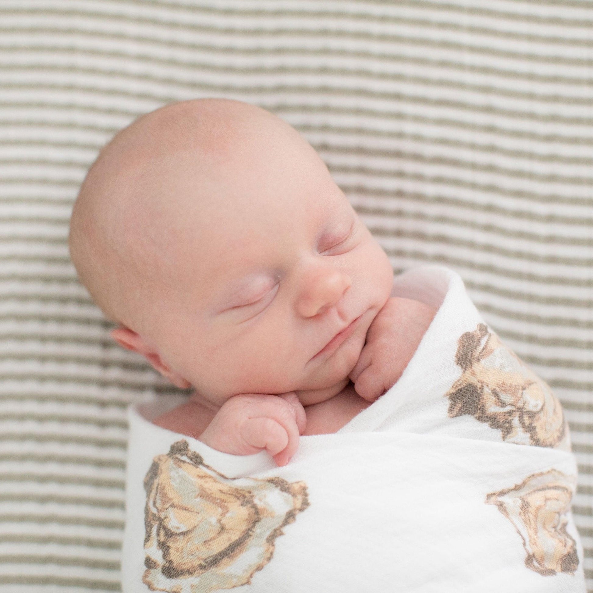 Baby gift set featuring an oyster-themed muslin swaddle blanket and burp cloth/bib combo, with "Aw Shucks!" text.