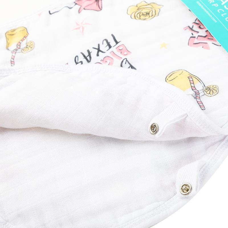 Texas-themed baby girl gift set with muslin swaddle blanket and burp cloth, featuring pink and white designs.