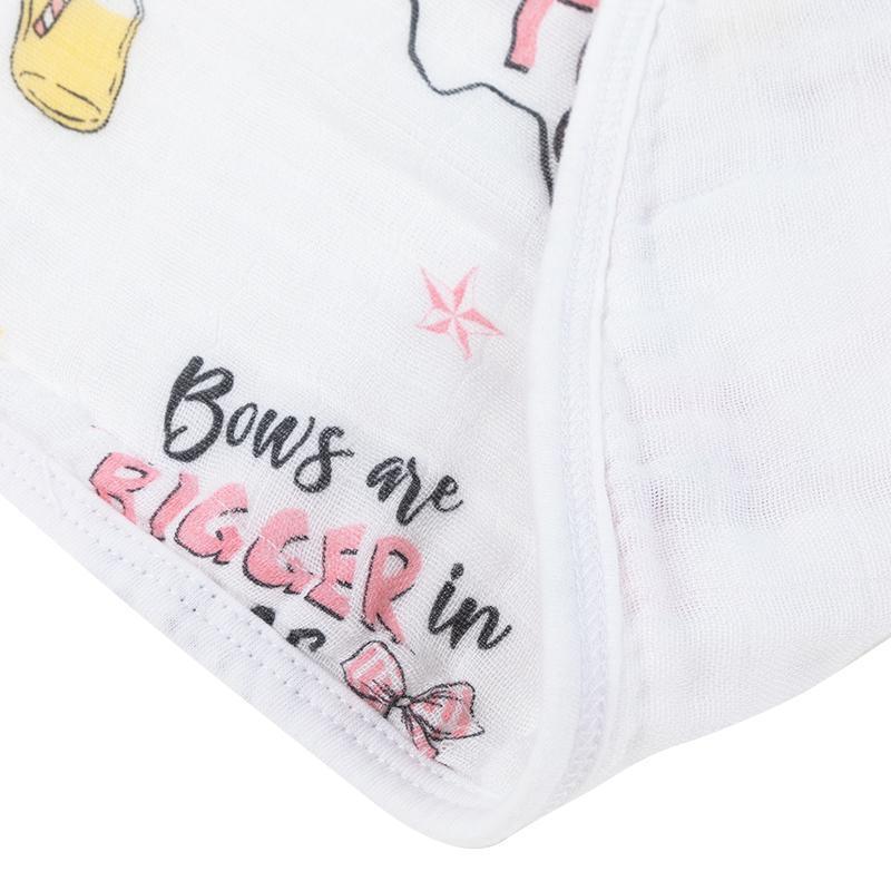 Texas-themed baby girl gift set with a muslin swaddle blanket and burp cloth, featuring pink and white designs.