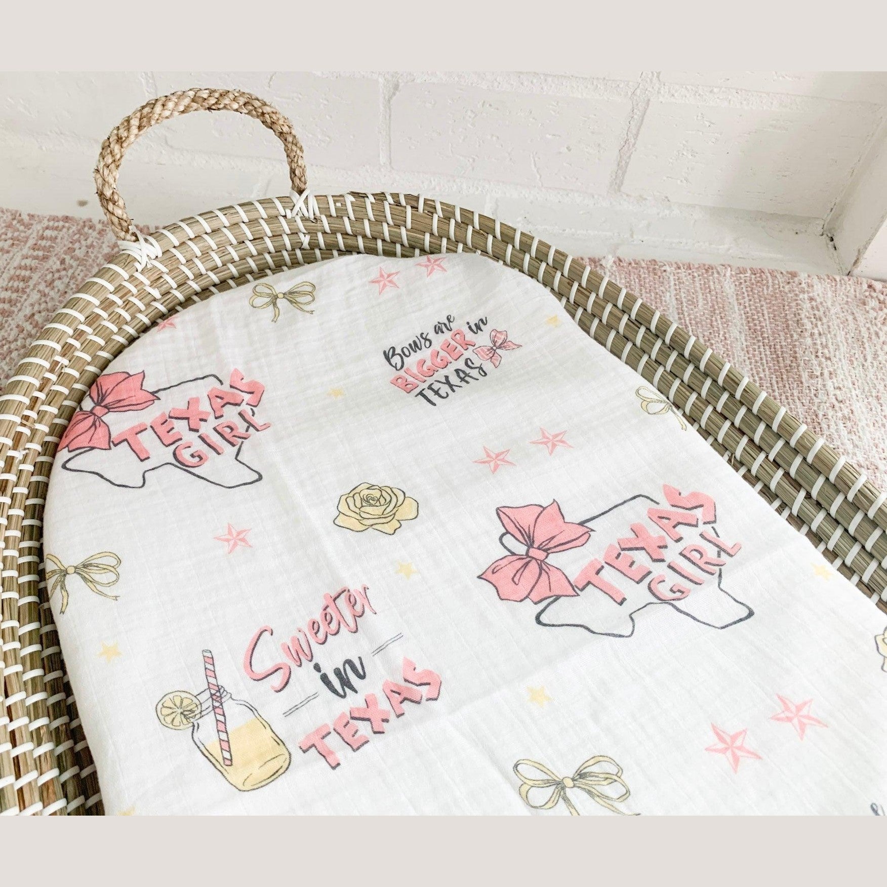 Texas-themed baby girl gift set with muslin swaddle blanket, burp cloth, and bib, featuring pink and white designs.
