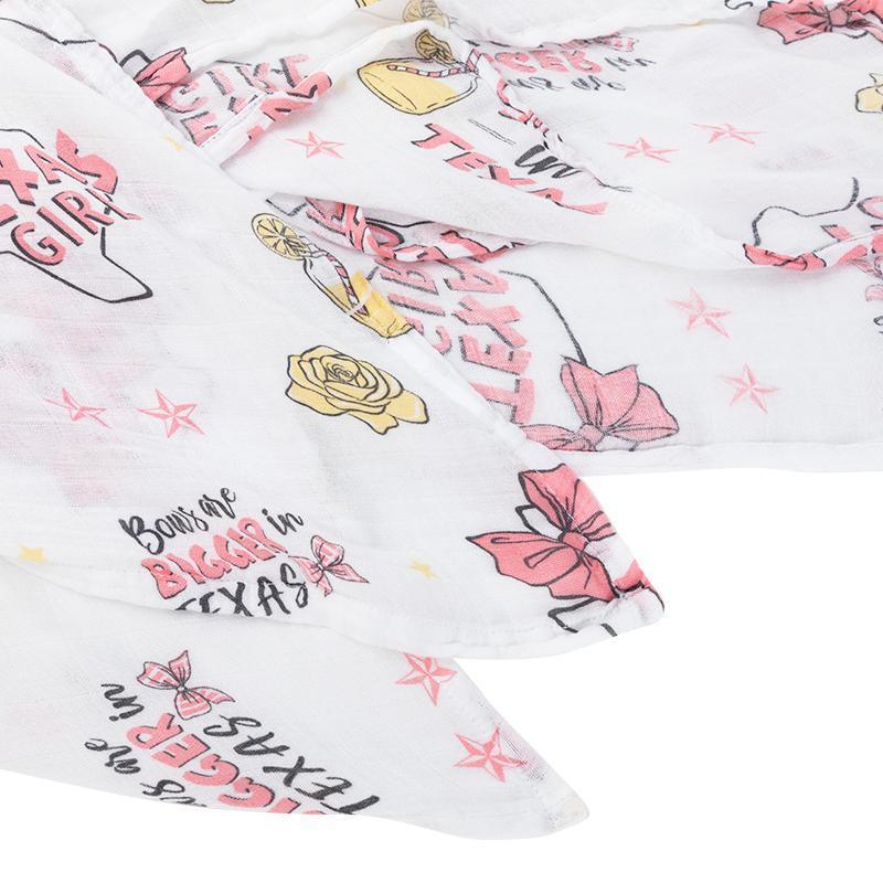 Texas-themed baby girl gift set with a muslin swaddle blanket and burp cloth, featuring pink and white designs.
