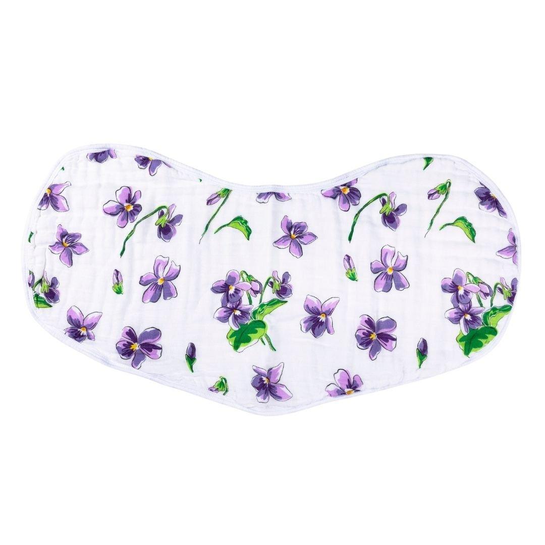 Gift set with a violet baby muslin swaddle blanket and matching burp cloth/bib combo, neatly folded.