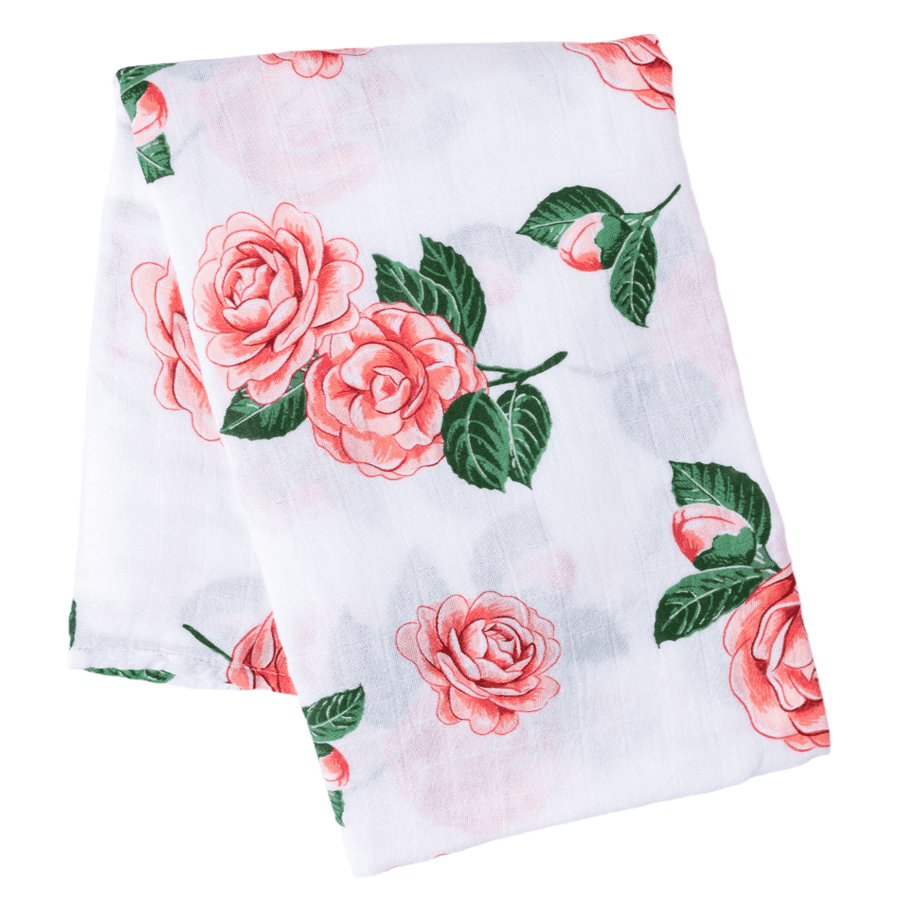 Camelia baby muslin swaddle blanket and burp cloth set with floral design, neatly folded on a white background.