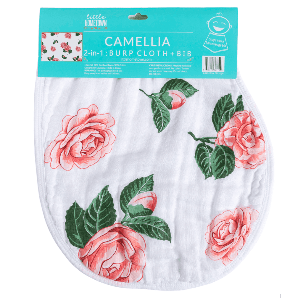 Gift set with a floral muslin swaddle blanket and matching burp cloth/bib, featuring pink camellia flowers.