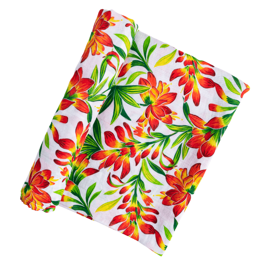 Prairie Fire baby muslin swaddle blanket and burp cloth set with vibrant floral design on a white background.