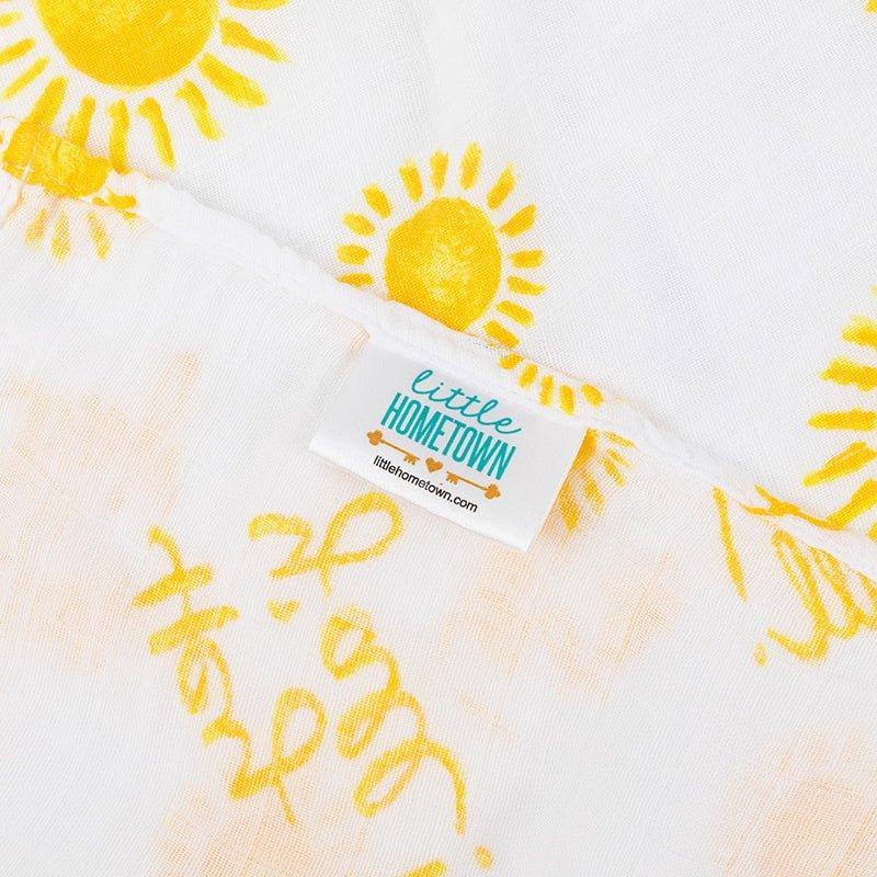White muslin swaddle blanket with "Hey Y'all" text in playful script, featuring pastel-colored stars and hearts.