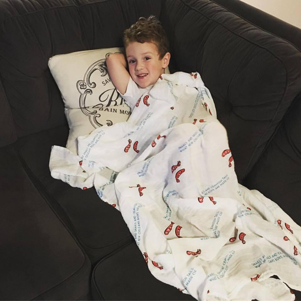 Louisiana-themed baby muslin swaddle blanket with state icons and "Louisiana Baby" text on a white background.