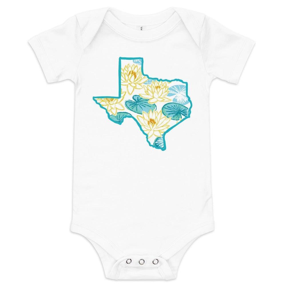 The Texas Dawn baby onesie in white, printed with a watercolor state shape in blue and gold.