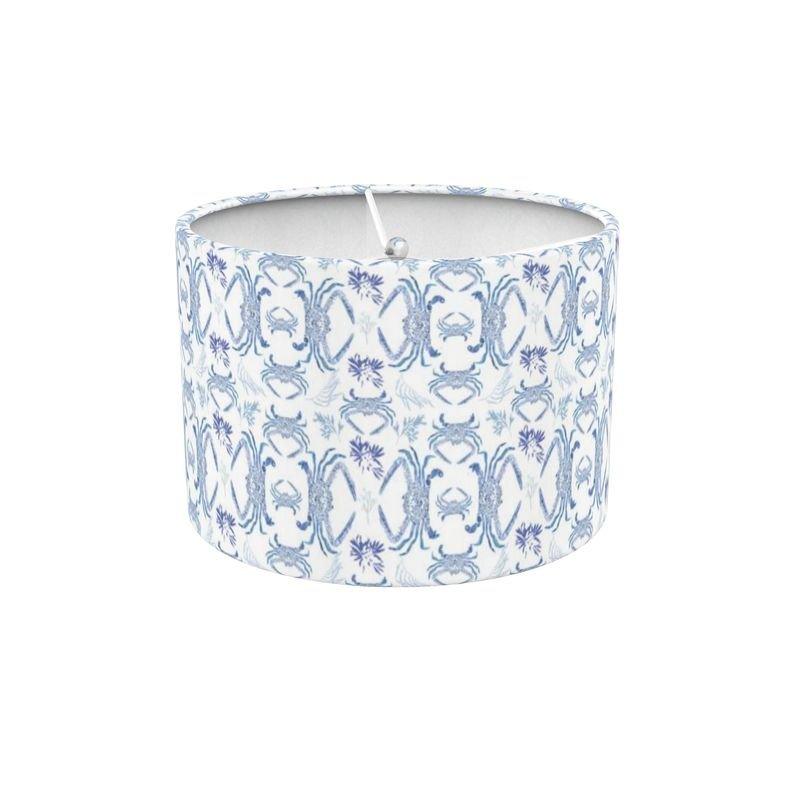 White lampshade with a detailed blue crab illustration, set against a neutral background.