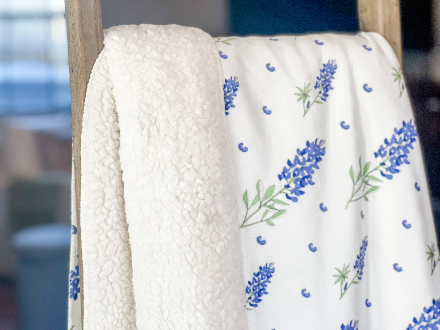 Soft plush throw blanket with vibrant bluebonnet flowers on a white background, measuring 60x80 inches.