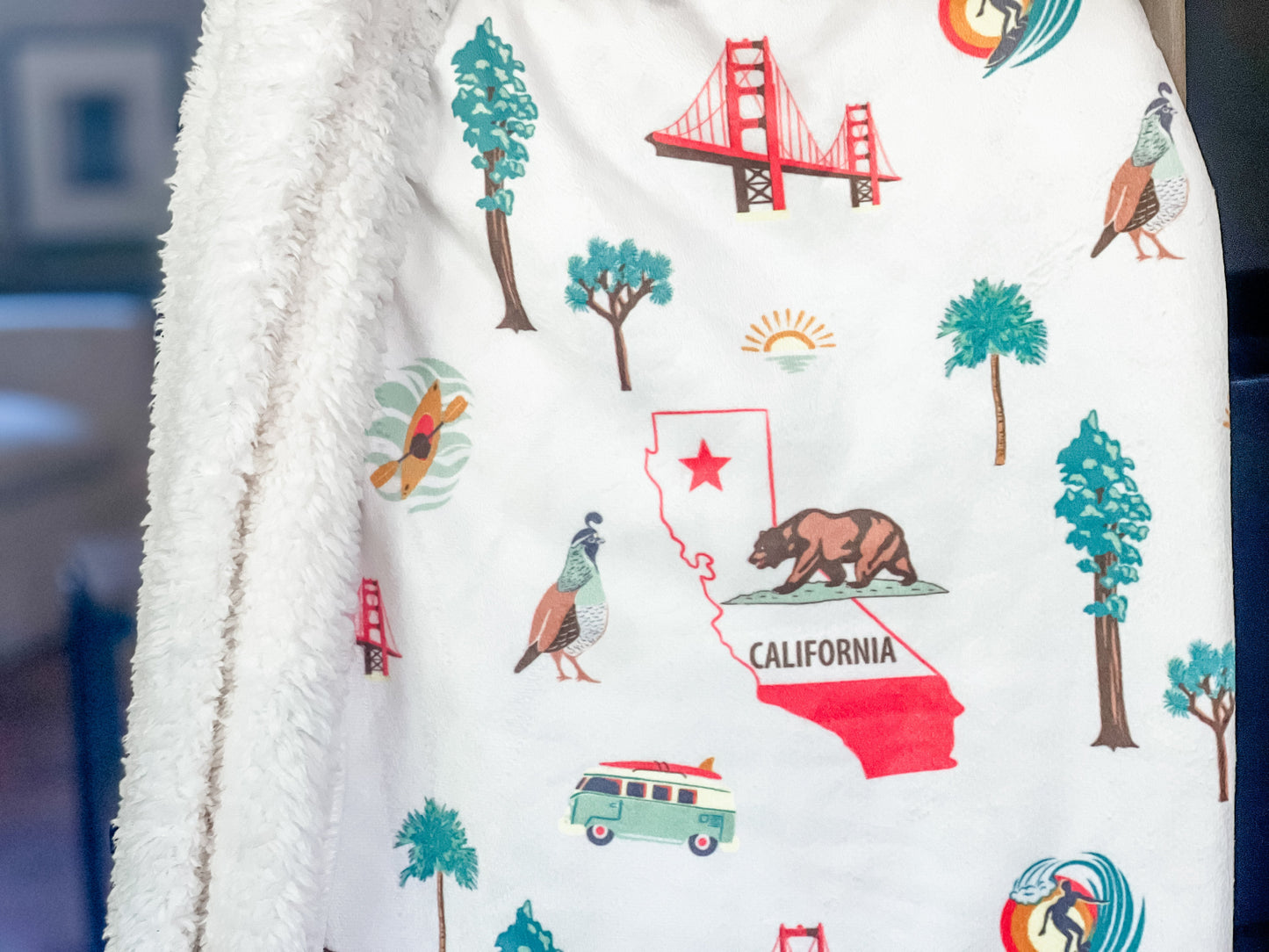 California-themed plush throw blanket with a vibrant sunset, palm trees, and "California" text in bold white letters.