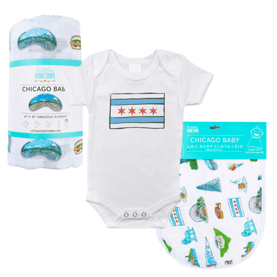 The Chicago Flag Bundle with its rolled muslin swaddle blanket, flag onesie and packaged burp cloth and bib.