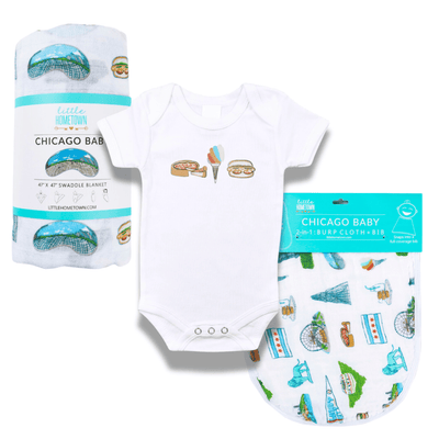The Chicago Foodie Bundle with a rolled muslin swaddle blanket, hot dog onesie and packaged burp cloth.