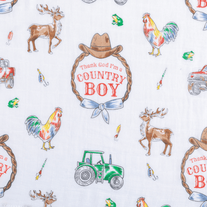 Country Boy muslin swaddle blanket with a playful farm animal print, featuring cows, pigs, and tractors.