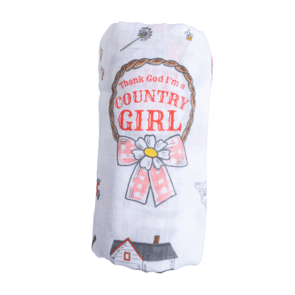 Country Girl muslin swaddle blanket with floral and cowgirl boot patterns on a white background.