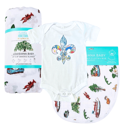 The Louisiana fleur de lis baby gift set with swaddle, bodysuit and burp cloth laid out ready to give.