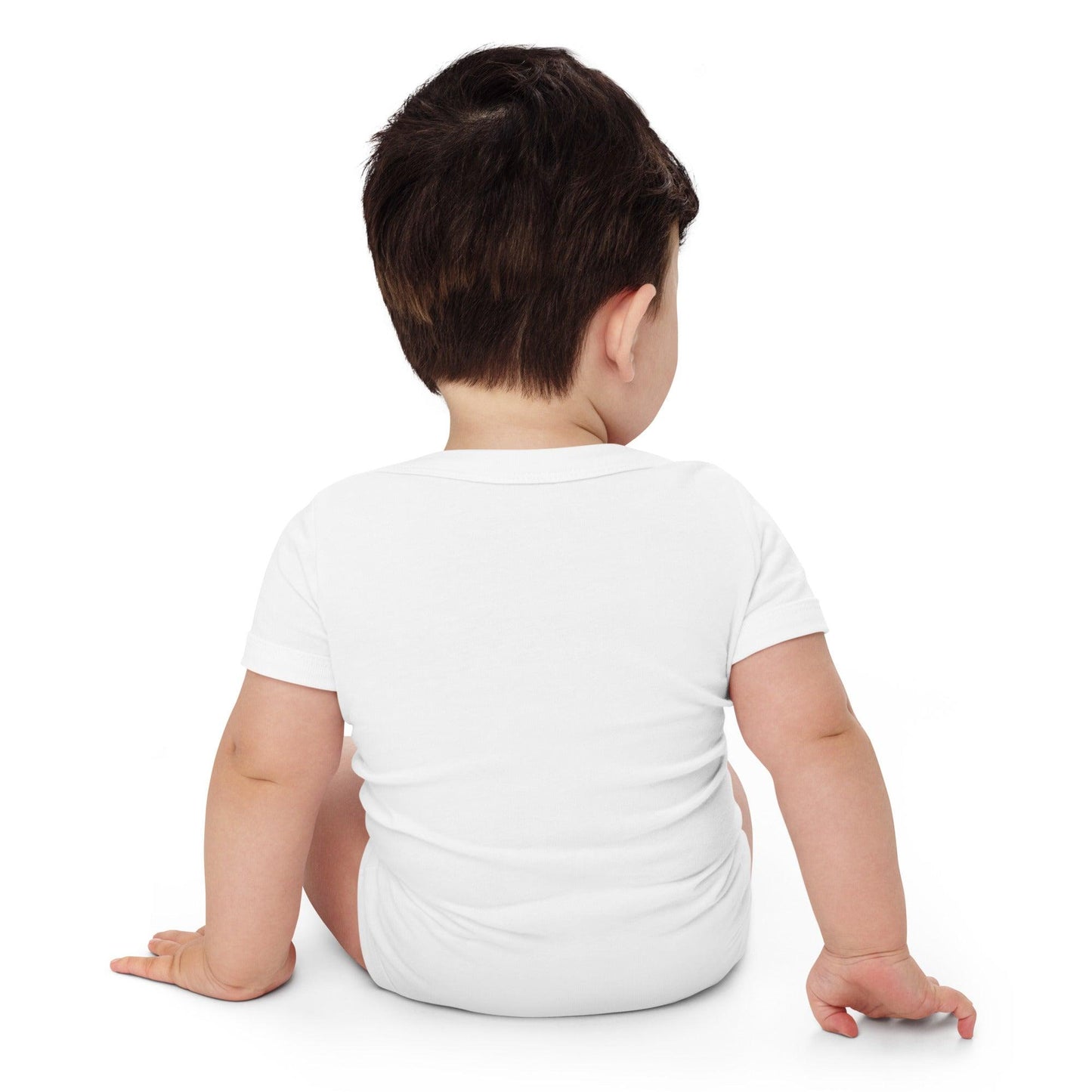 The back of a baby modelling a white baby onesie while in front of a white background