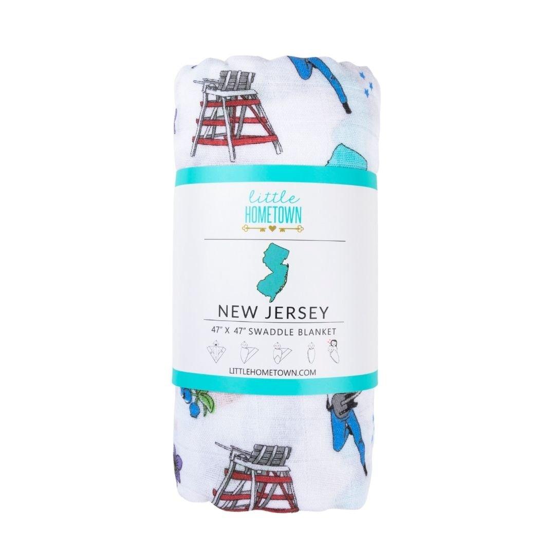 Cozy New Jersey-themed baby swaddle featuring iconic state symbols and landmarks in vibrant colors.