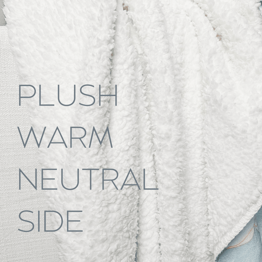 The back of Little Hometown's plush blanket showing the warm neutral side of the white fleece backing with the words "PLUSH WARM NEUTRAL SIDE" written in gray letters