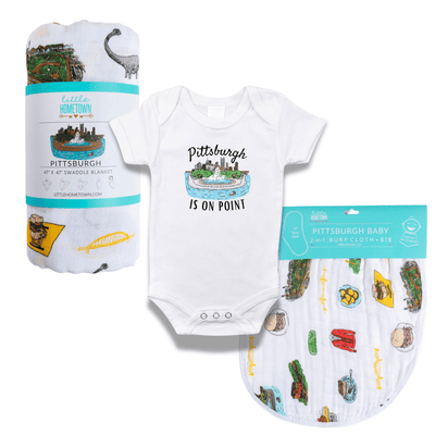 The Pittsburgh On Pointe baby gift set with a printed onesie, a rolled swaddle and a matching burp cloth.
