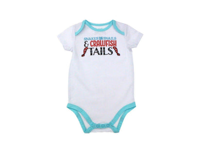 White baby onesie with "Snakes and Snails and Crawfish Tails" text, featuring playful crawfish illustrations.