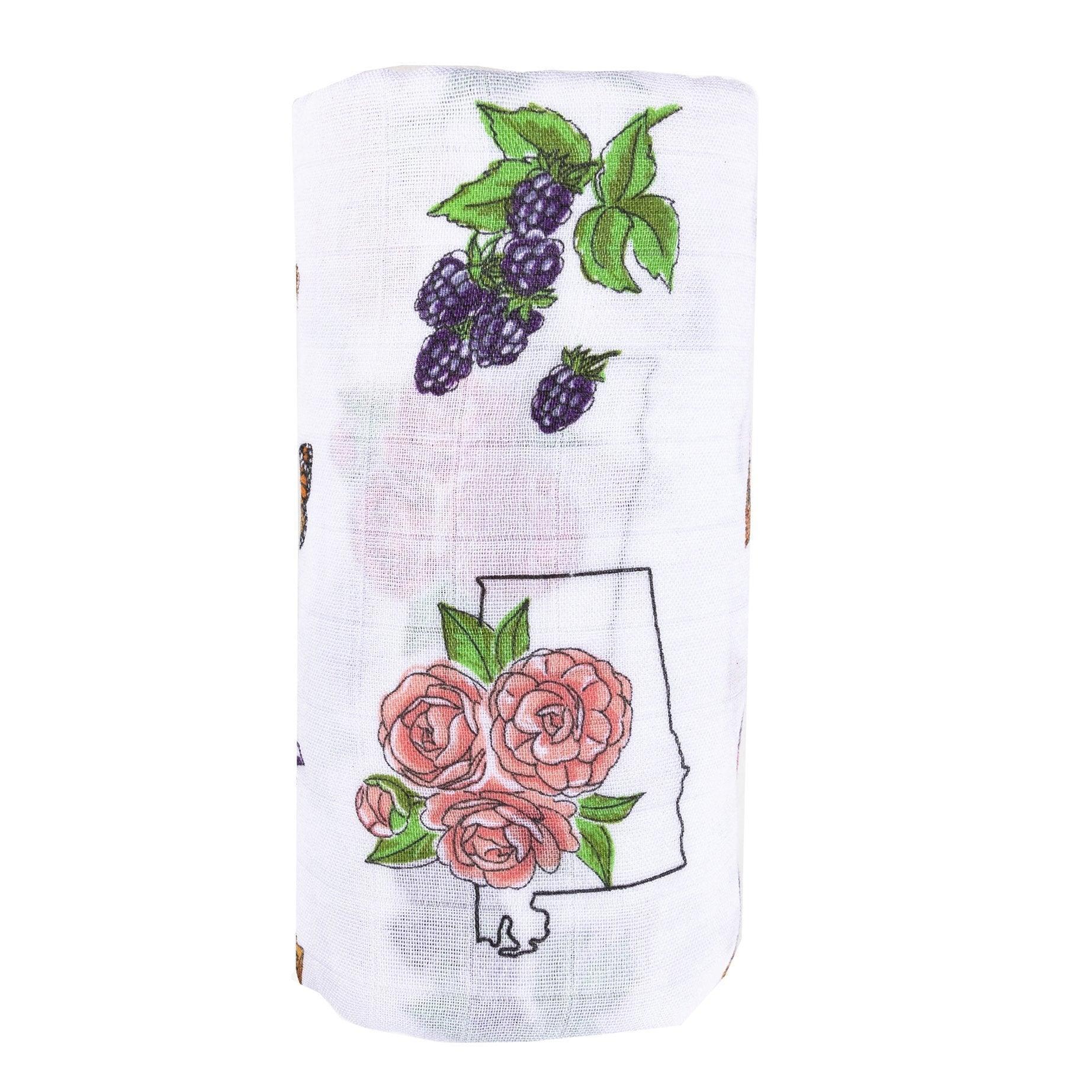 White muslin swaddle blanket with delicate pink and green floral pattern, labeled "Alabama Baby" in elegant script.