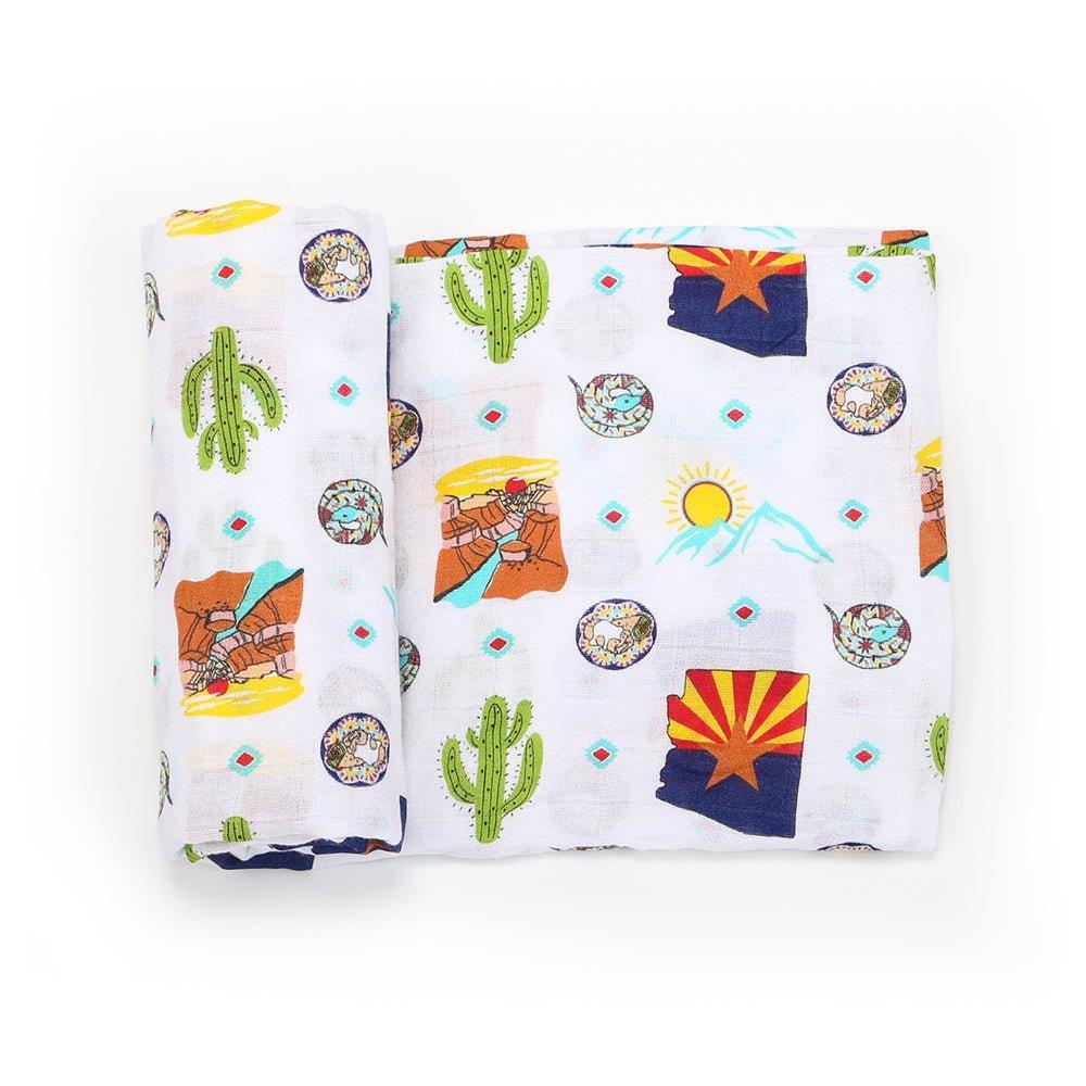 Soft muslin swaddle blanket with Arizona-themed illustrations, including cacti, mountains, and desert animals.