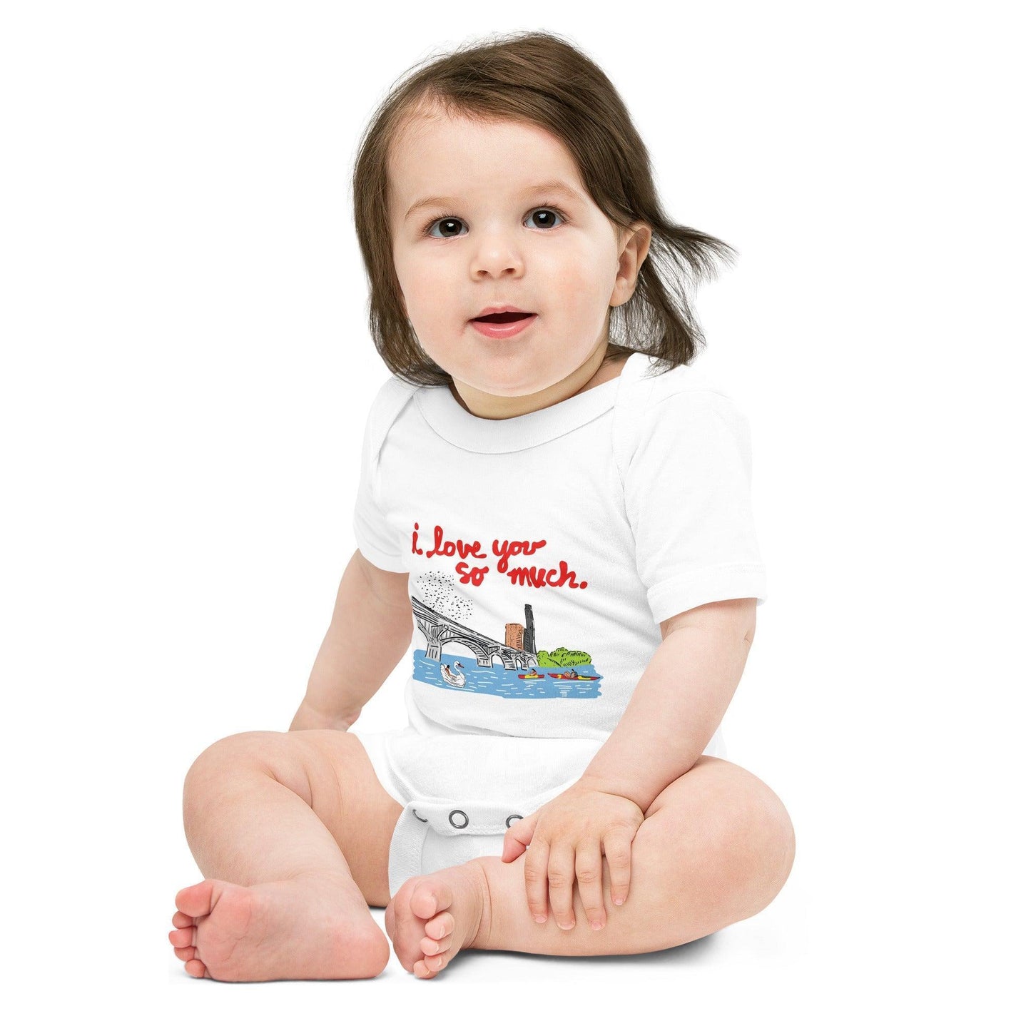 A baby wearing a white baby onesie with "Austin, I love you so much" in red text over a citiscape of the Austin bridge ducks, and kayakers, displayed on a plain background.