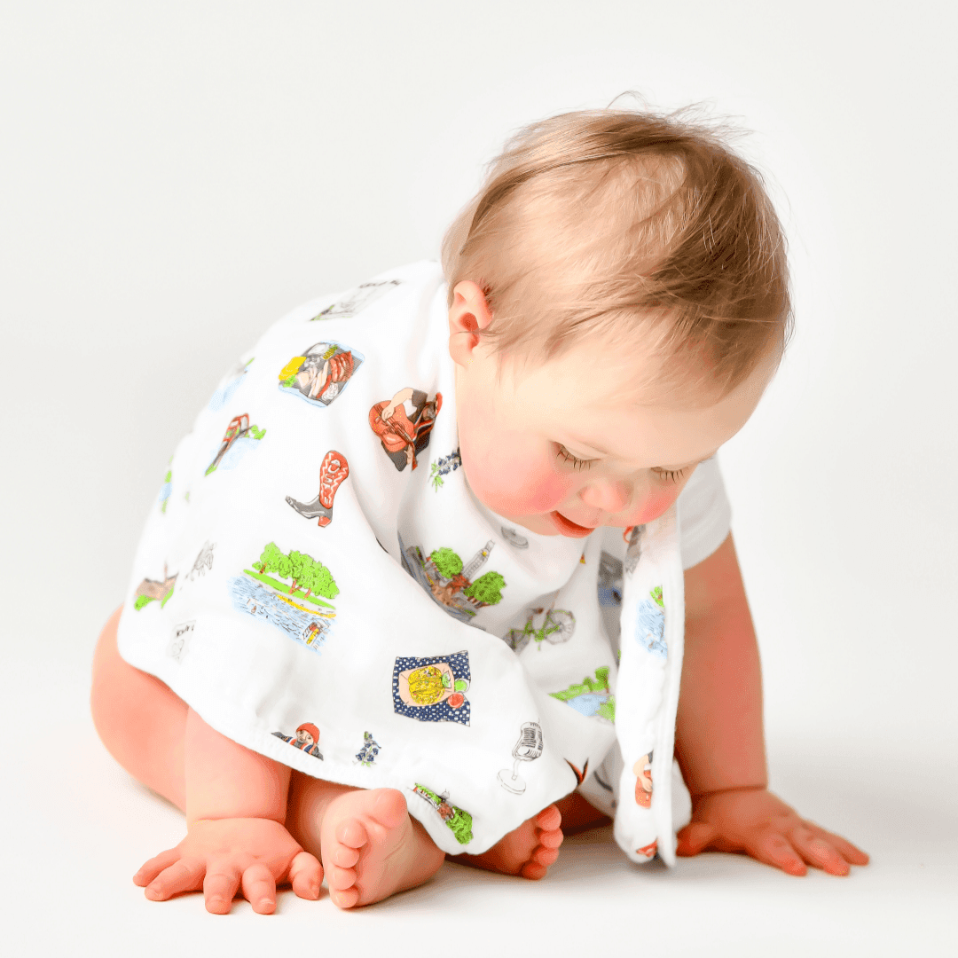 Baby bib and burp cloth set featuring a cute Austin cityscape design with landmarks and playful illustrations.