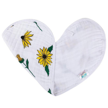 Baby bib and burp cloth set with black-eyed Susan floral pattern on white fabric, displayed on a wooden surface.