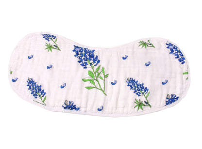 Baby bib and burp cloth set with bluebonnet floral pattern on white fabric, displayed on a wooden surface.