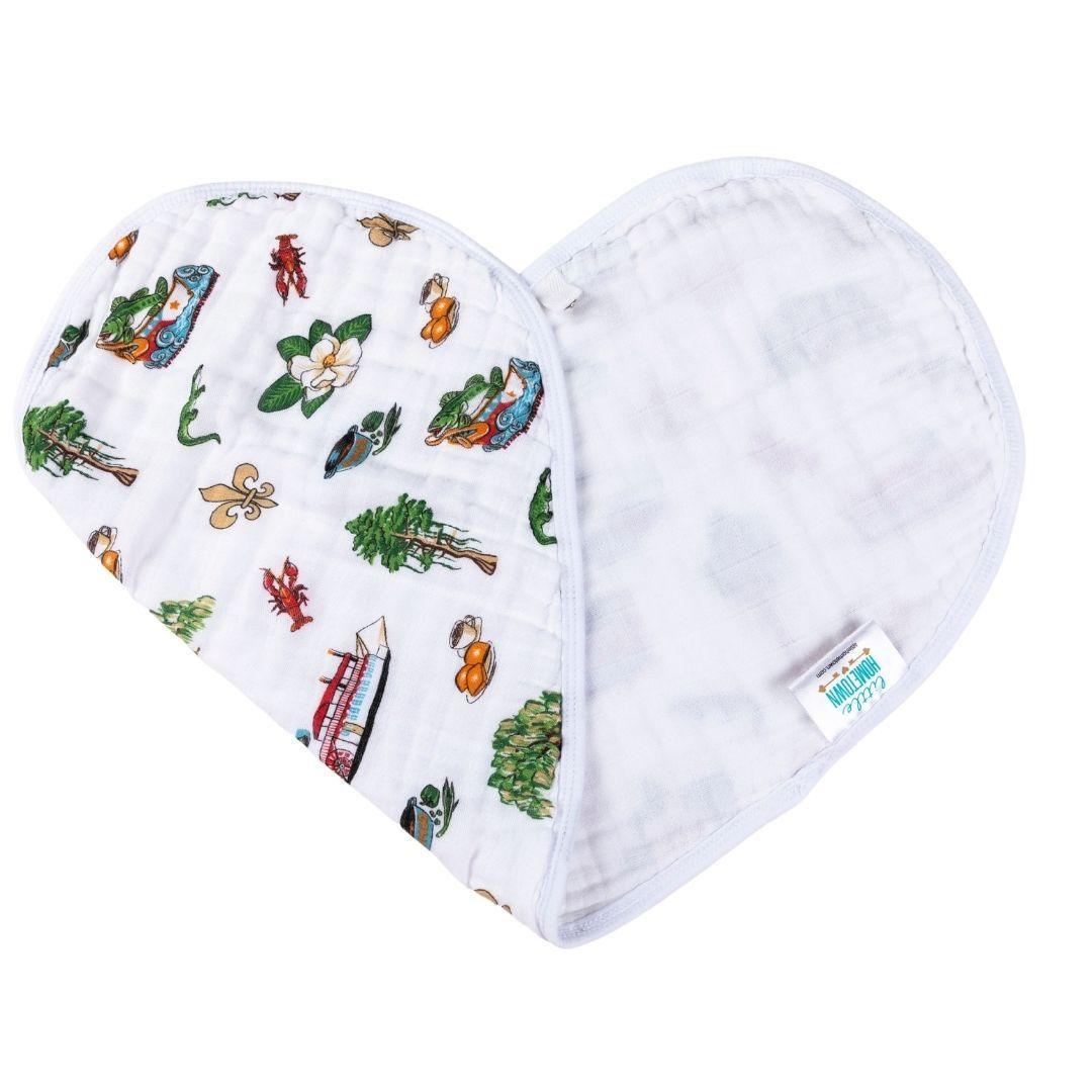 White baby bib and burp cloth set with "Louisiana Baby" text and state outline, featuring playful icons.