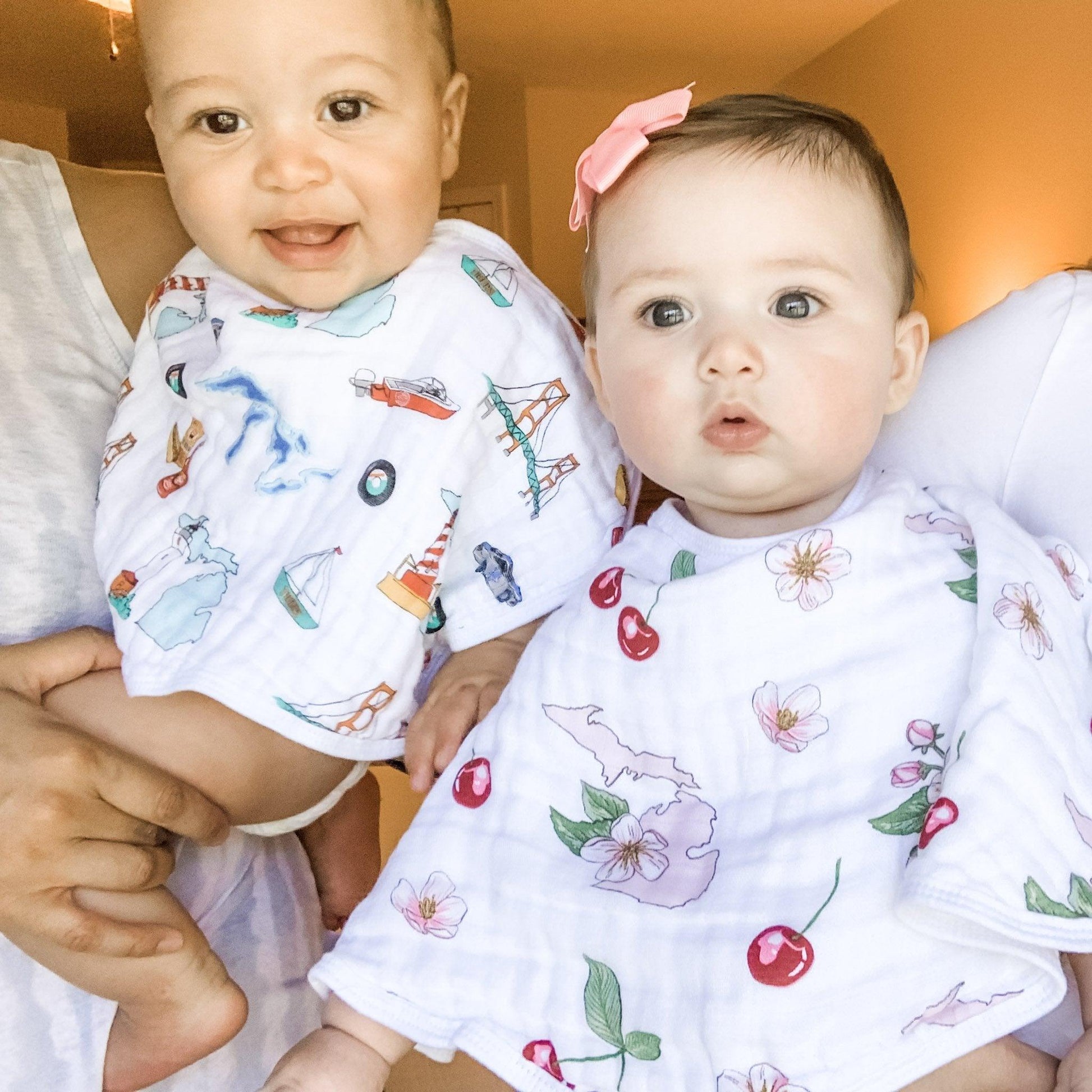 Baby bib and burp cloth set with Michigan floral design, featuring blue and yellow flowers on a white background.