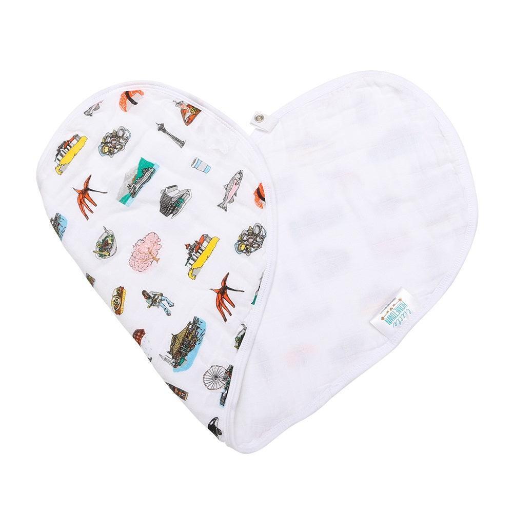 Baby bib and burp cloth set with Seattle landmarks, including Space Needle and Mount Rainier, in soft pastel colors.