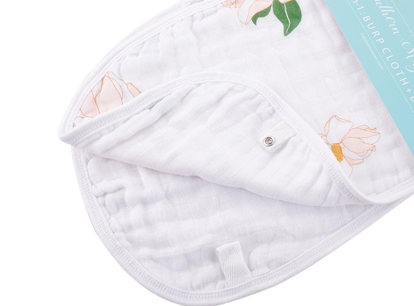 Baby bib and burp cloth set with Southern Magnolia print, featuring delicate white flowers on a soft pink background.