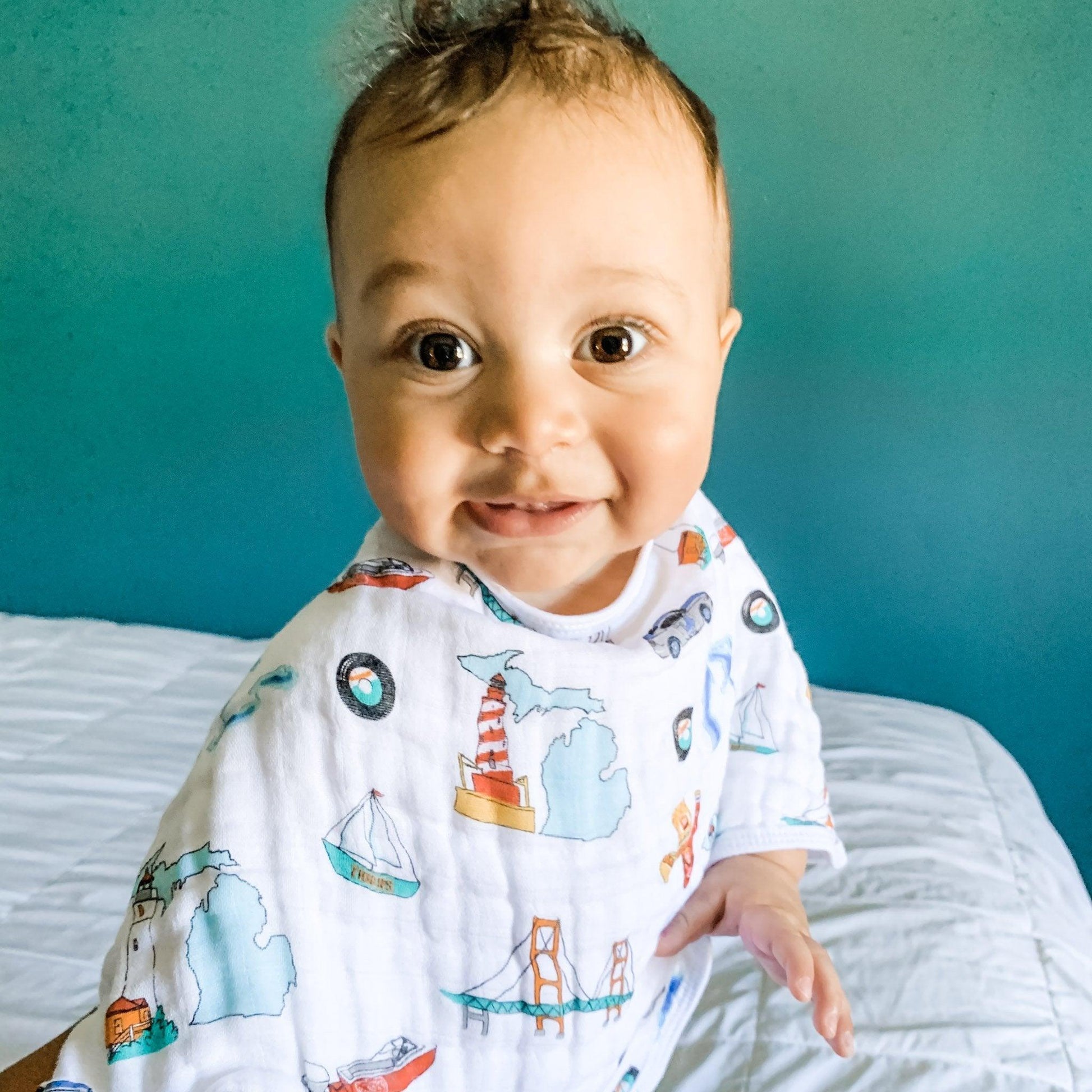 Baby burp cloth and wraparound bib set featuring Michigan-themed designs, including state outline and landmarks.