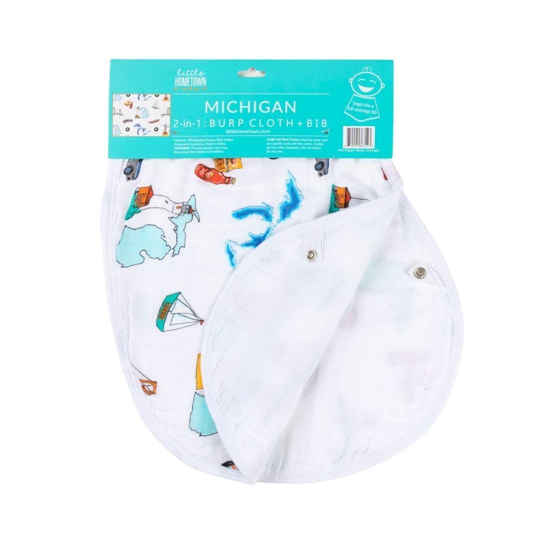 Baby wearing a Michigan-themed bib and burp cloth, featuring a map and icons of the state in blue and white.