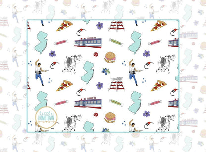 New Jersey-themed baby burp cloth and wraparound bib set with state icons and landmarks in soft pastel colors.