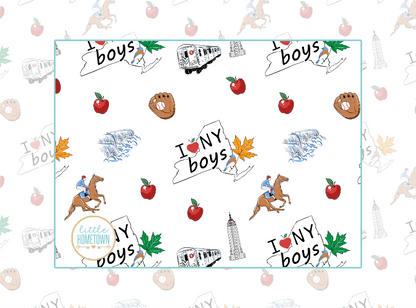 Baby burp cloth and wraparound bib set with New York-themed illustrations, including taxis and skyscrapers.