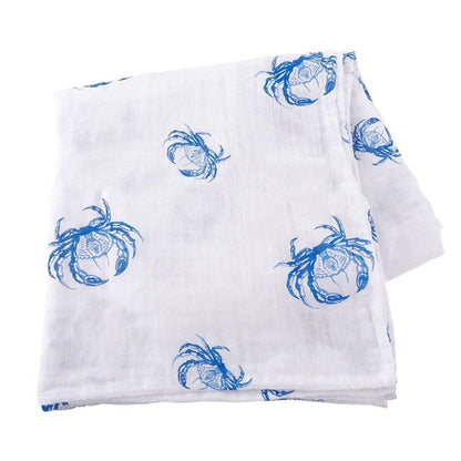 Soft muslin swaddle blanket with blue crab illustrations, perfect for babies, on a white background.