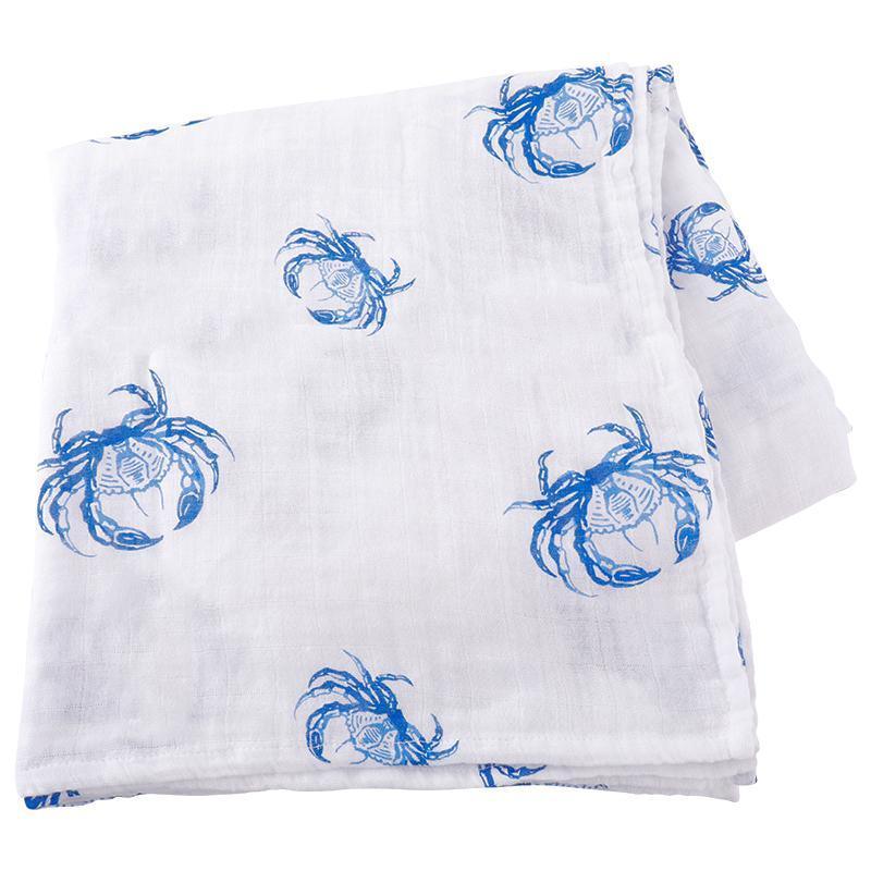 White muslin swaddle blanket with blue crab illustrations, evoking a coastal theme, laid flat on a white background.