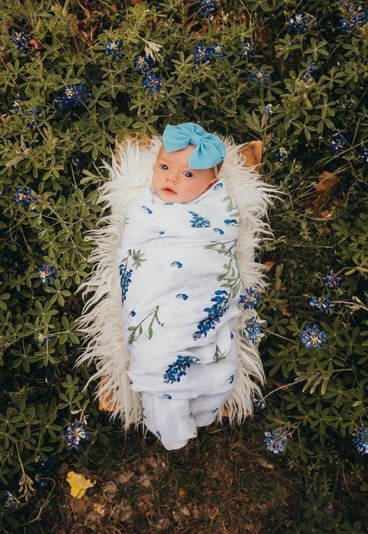 Soft muslin swaddle blanket with delicate bluebonnet floral pattern, perfect for babies, by Little Hometown.