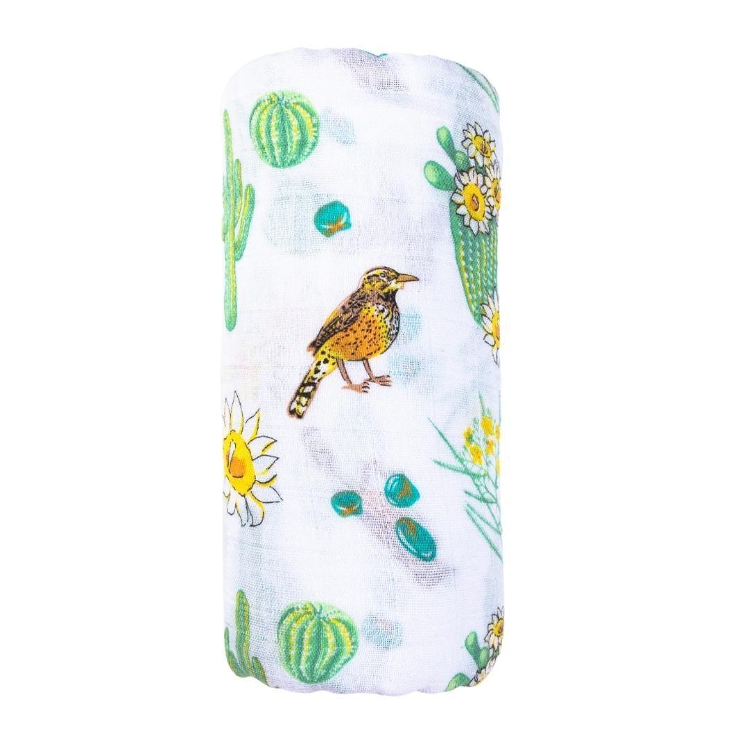 Soft muslin swaddle blanket with vibrant cactus and blossom print, perfect for a cozy and stylish baby wrap.