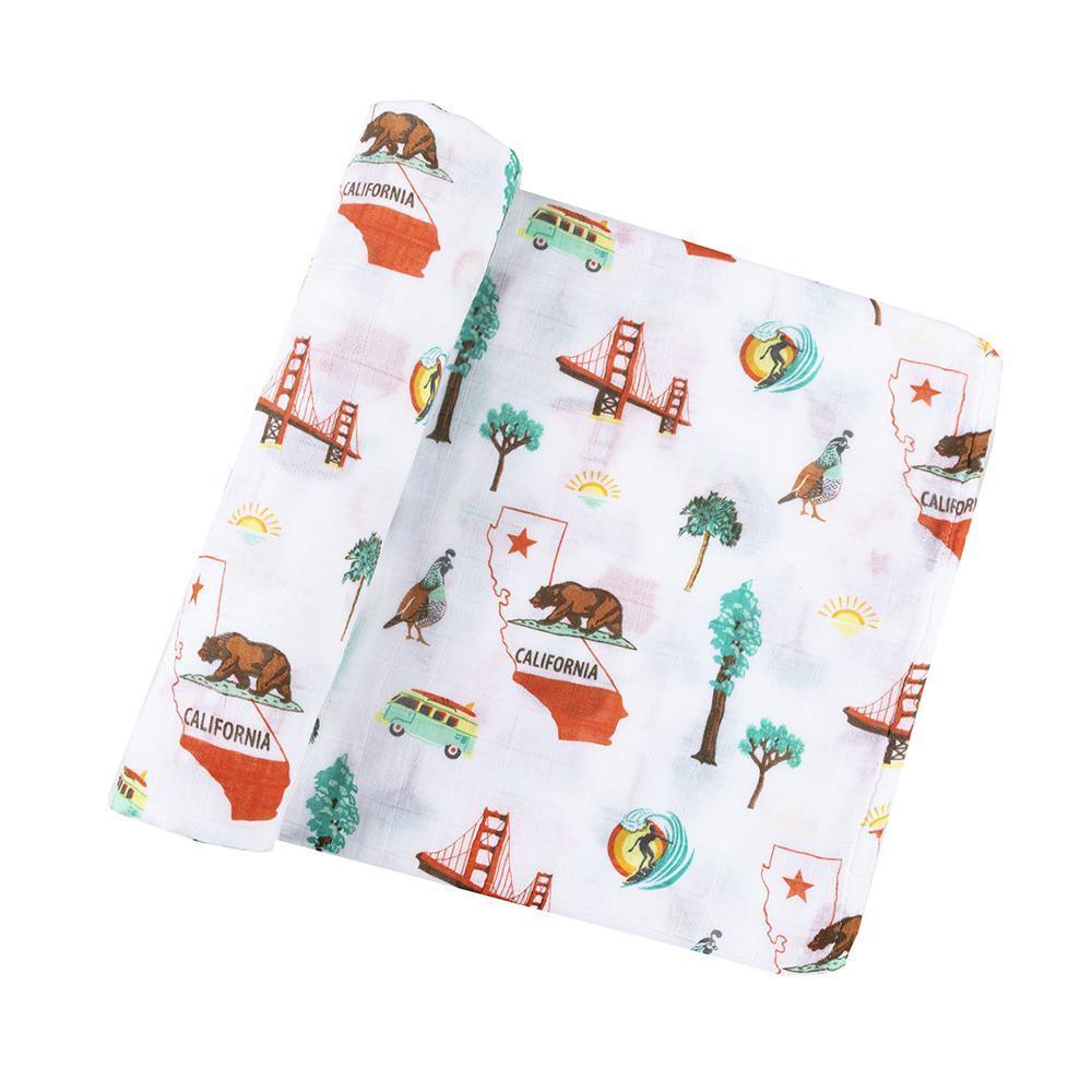 White muslin swaddle blanket with California-themed illustrations, including palm trees, surfboards, and bears.