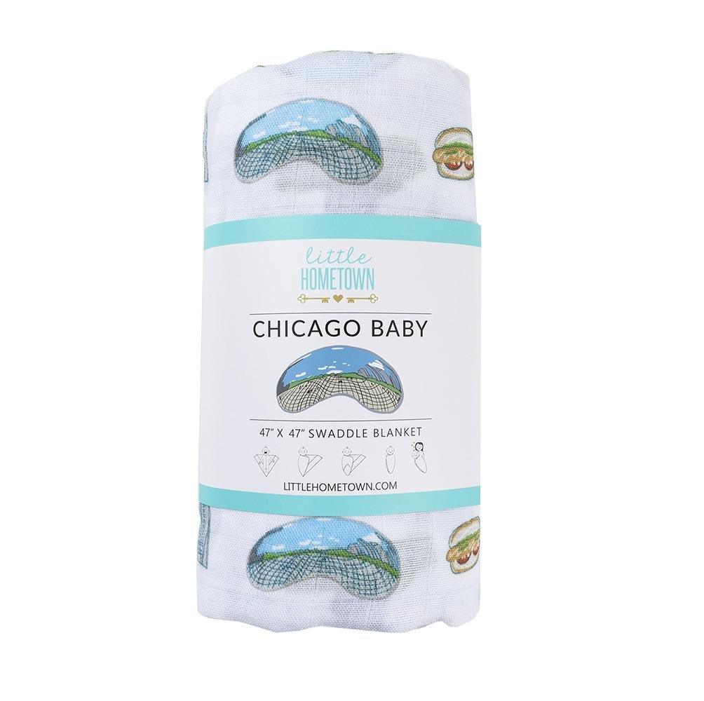 White muslin swaddle blanket with Chicago landmarks like the Willis Tower, Navy Pier, and the Bean in colorful illustrations.