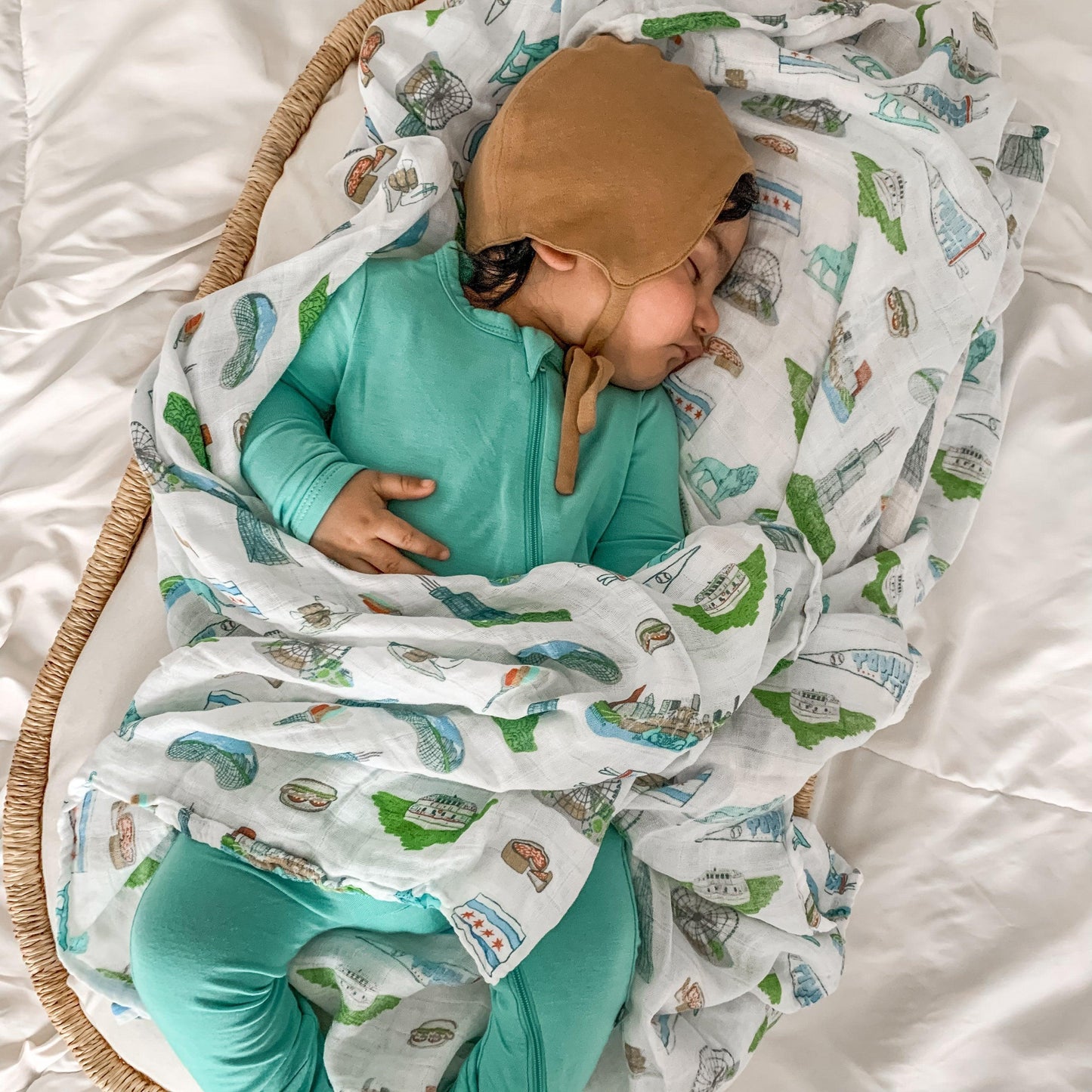 Chicago-themed baby muslin swaddle blanket featuring iconic landmarks and symbols in soft pastel colors.