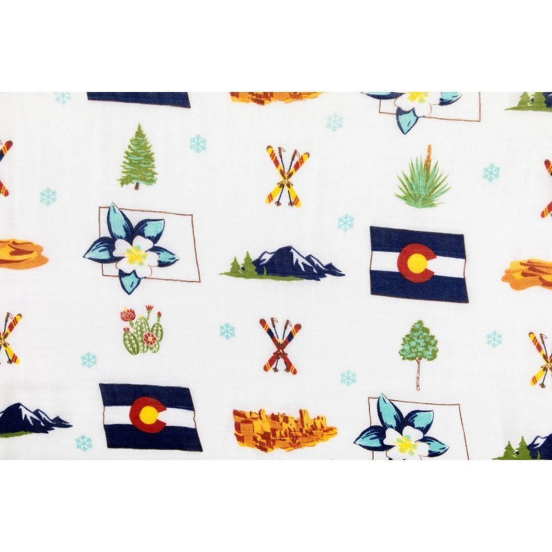 Colorado-themed muslin swaddle blanket featuring mountains, trees, and wildlife in soft pastel colors.