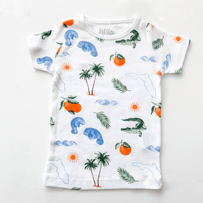 Toddler pajamas with Florida-themed illustrations, including palm trees, oranges, and alligators, on a white background.